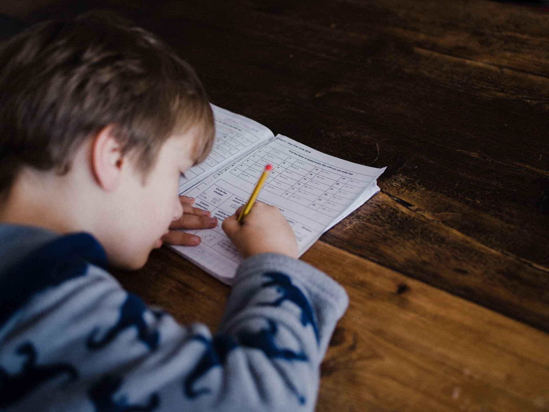 Child filling out educaitonal workbook